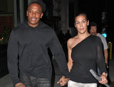 Nicole Threatt and her former spouse Dr Dre holding hands.